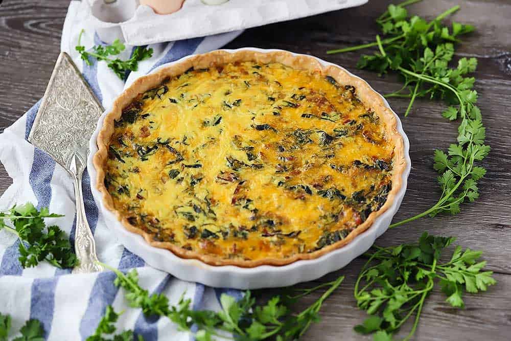Horizontal photo of a cooked quiche.