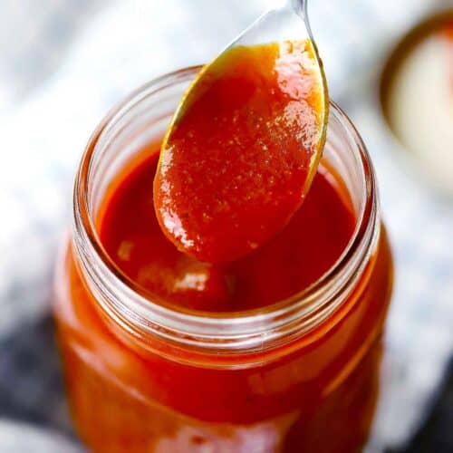 Square photo of homemade BBQ sauce on a spoon.