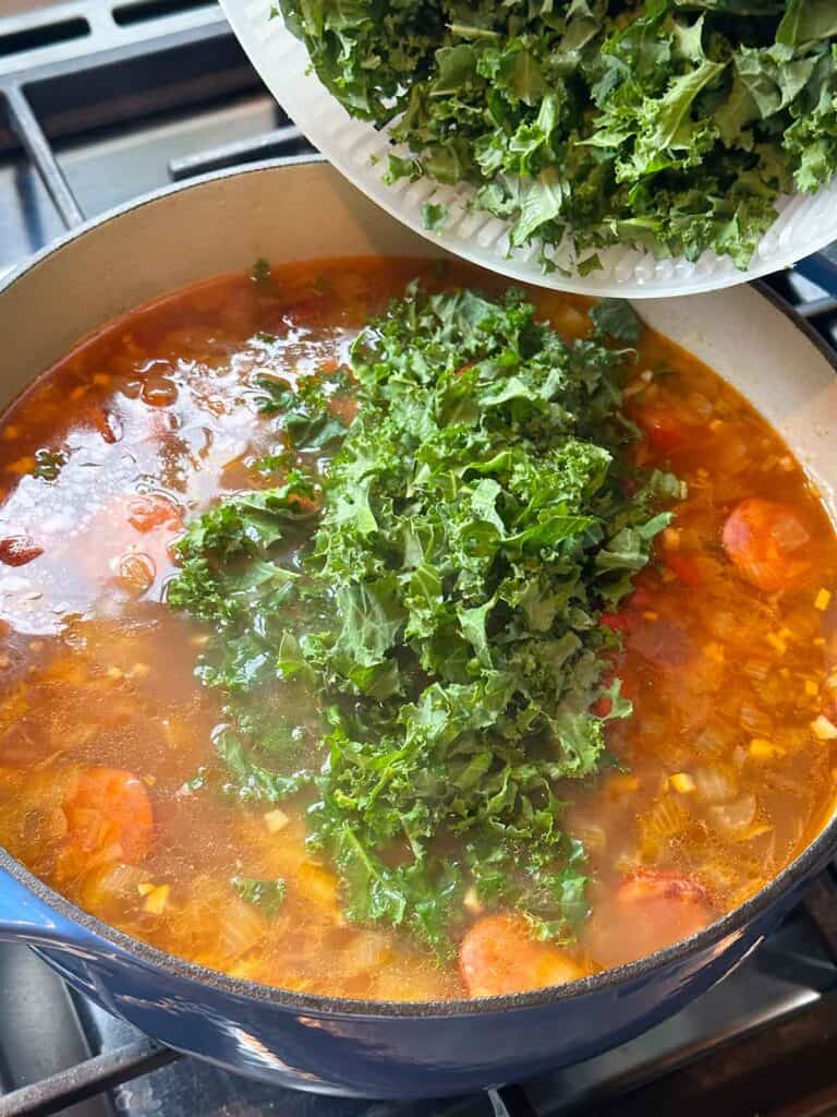 Adding kale to Portuguese caldo verde.