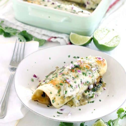 These Chicken and Spinach Enchiladas Verdes are my FAVORITE enchiladas! The recipe is freezable and packed with healthy greens, the chicken is marinated in a delicious jalapeño garlic mixture, and they're topped with jarred roasted tomatillo salsa for a quick and easy shortcut.