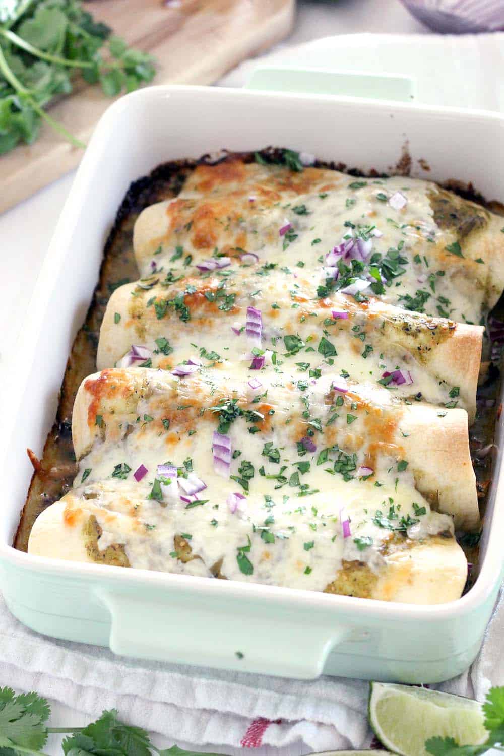 These Chicken and Spinach Enchiladas Verdes are my FAVORITE enchiladas! The recipe is freezable and packed with healthy greens, the chicken is marinated in a delicious jalapeño garlic mixture, and they're topped with jarred roasted tomatillo salsa for a quick and easy shortcut.