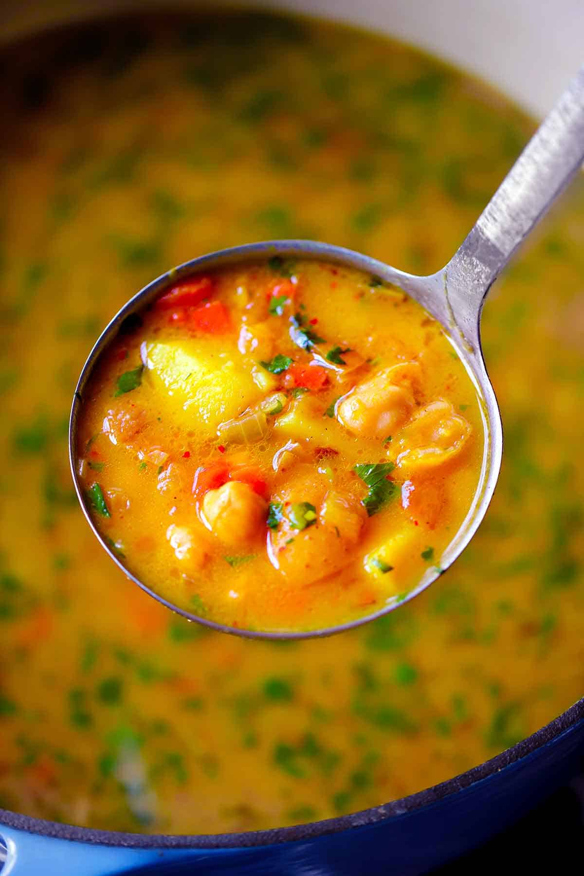 A ladle full of curry soup.