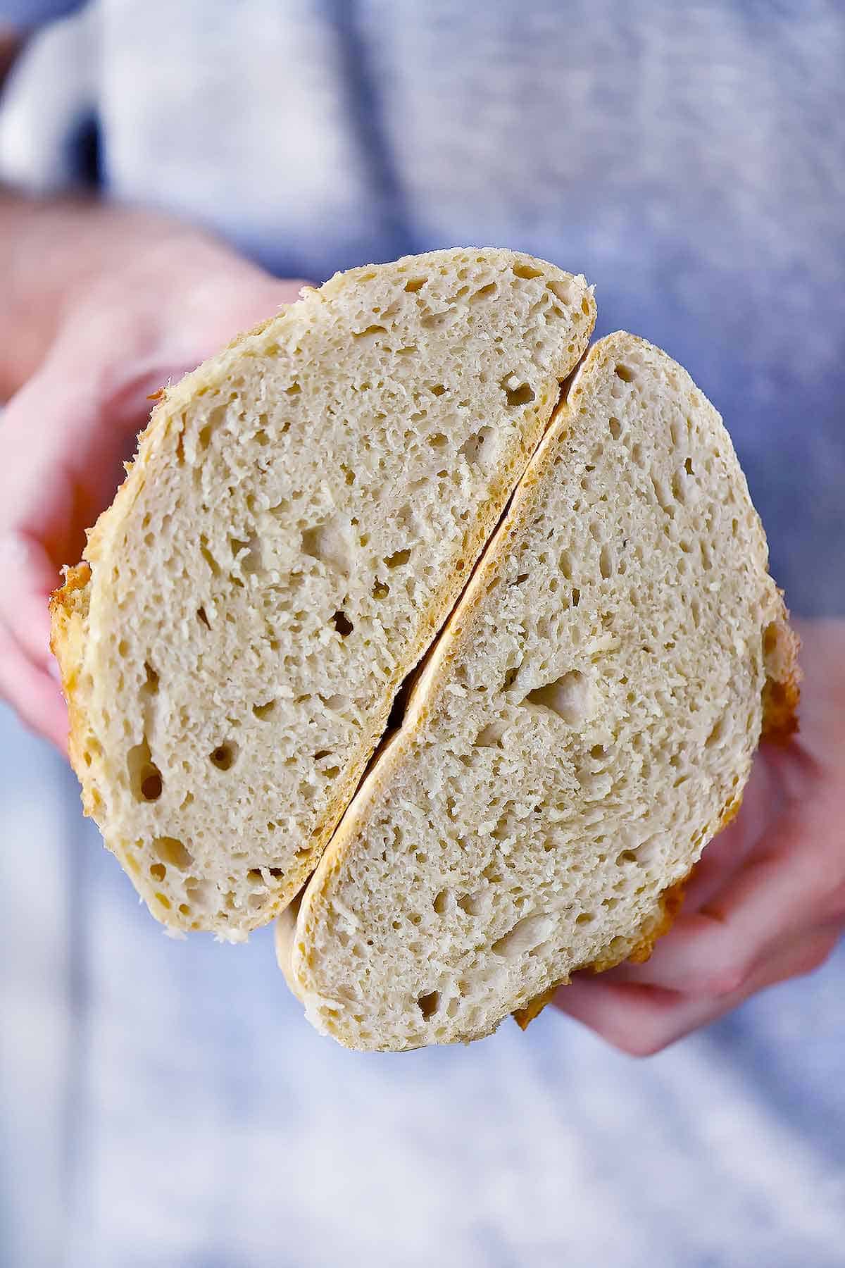 Inside of Dutch Oven no knead bread being held by a person.