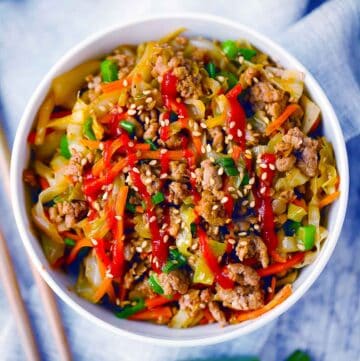 Square photo of egg roll in a bowl.