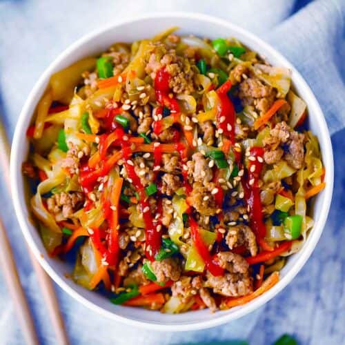 Square photo of egg roll in a bowl.