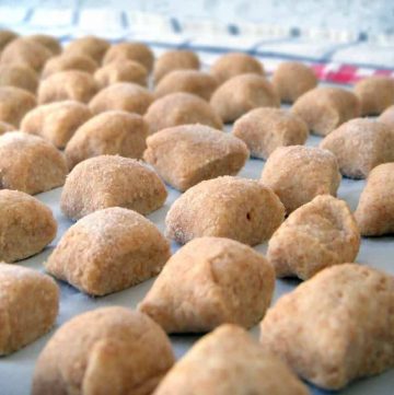 Whole Wheat Ricotta Gnocchi in rows on a work surface.