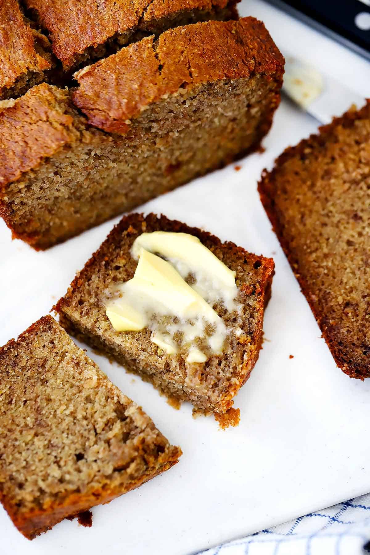 warm banana bread with salted butter spread on top.