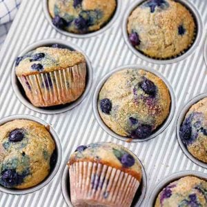 square photo of healthy blueberry muffins in a muffin pan.