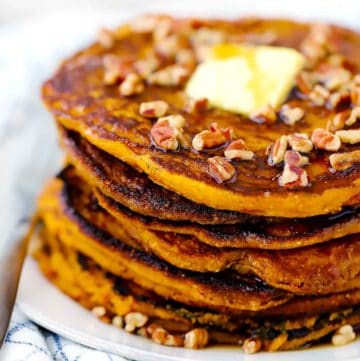 Close up photo of a stack of pumpkin pancakes.
