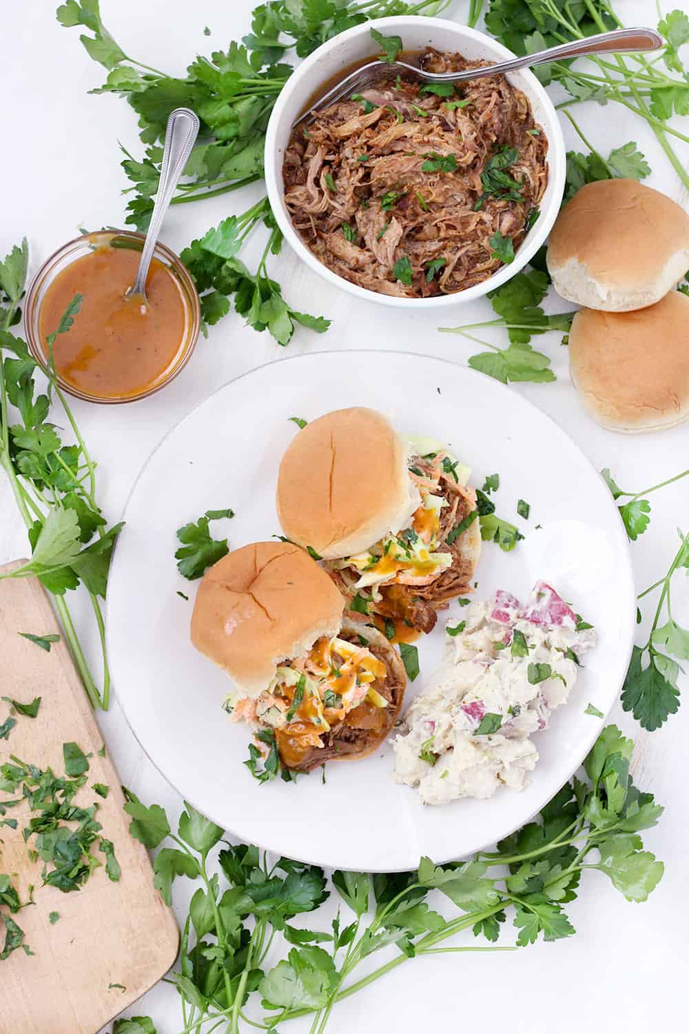 This Instant Pot Pulled Pork is a quick and easy recipe to feed a crowd! I love it served on slider buns with coleslaw or on tortillas with cilantro and onion. It's inexpensive, and the leftovers freeze beautifully.