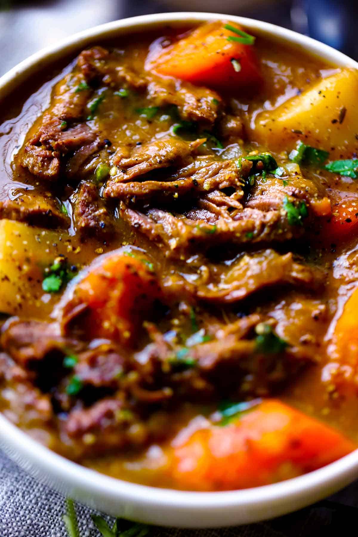 Close up photo of Irish lamb stew in a white bowl.