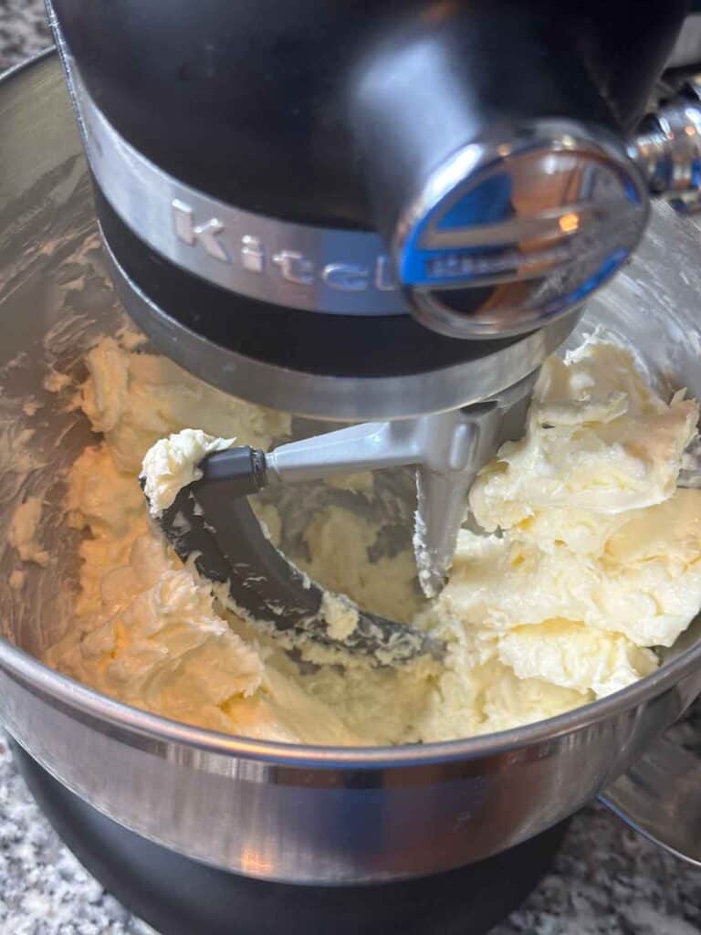 Softened butter in a standing mixer.