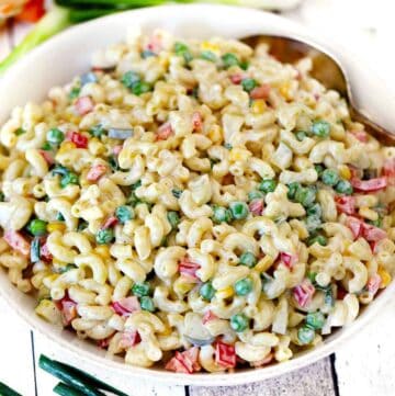 Square photo of macaroni salad in a white bowl.