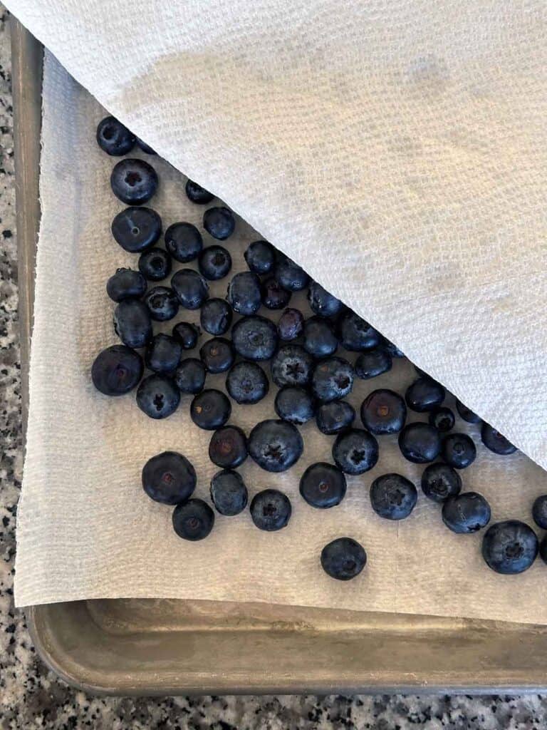 Drying blueberries with paper towels.