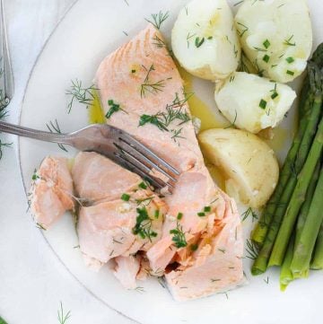 This poached salmon recipe comes out perfectly moist and flaky every time! It's drizzled in a delicious chive butter, takes only 15 minutes, and is a perfect low-carb, keto recipe.