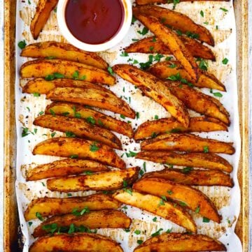 Square photo of crispy baked potato wedges.
