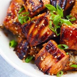 Square photo of salmon bites close up.