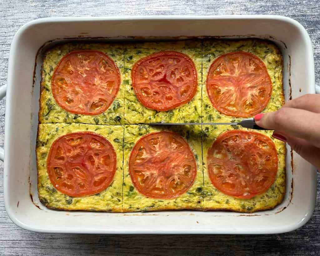 Cutting a Greek Zucchini Casserole (Sfougato) into six pieces.