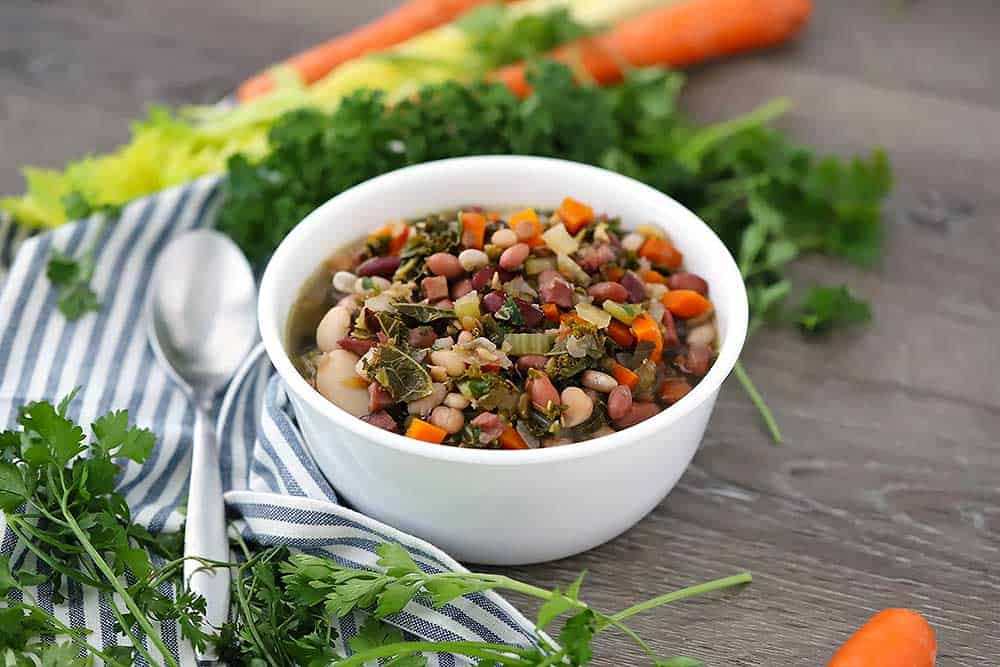 Horizontal photo of a white bowl with soup in it.