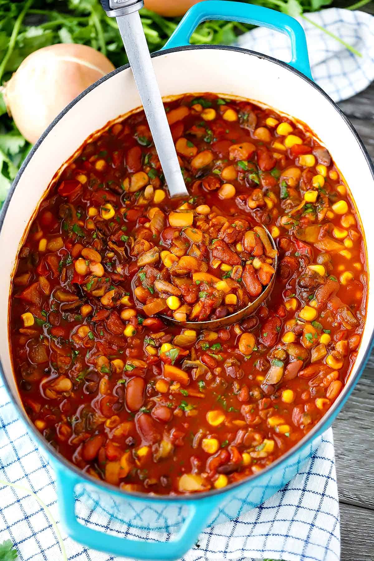 A dutch oven full of smoky vegetarian chili.