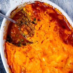 Square photo of a sweet potato shepherd's pie with a scoop taken out.