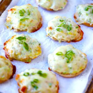 Square photo of English Muffin tuna melts on a baking sheet.