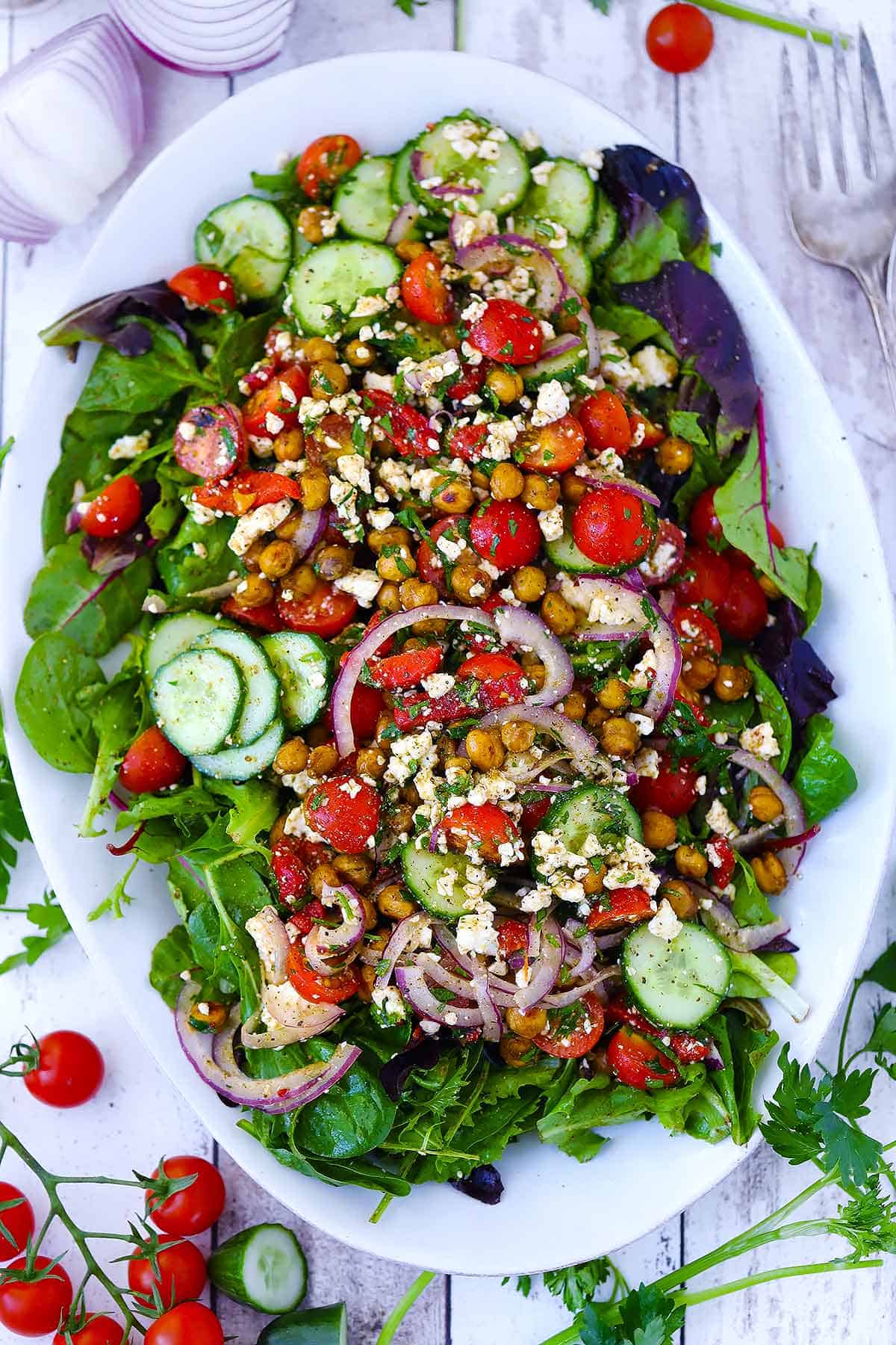 Overhead photo of a white platter with roasted chickpea salad.