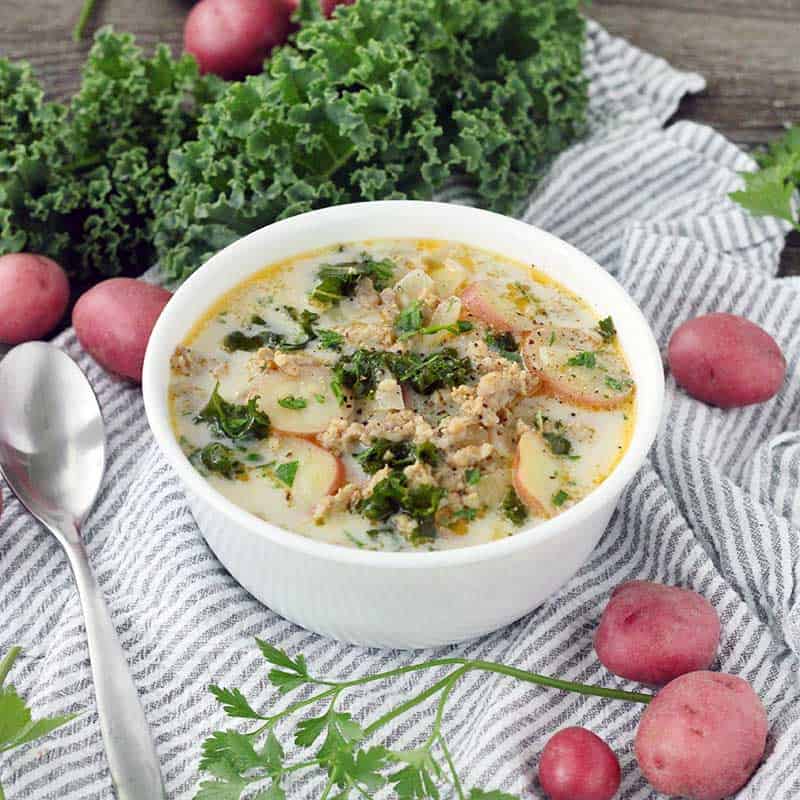 The Olive Garden's famous Zuppa Toscana is so easy to make from scratch at home with only a few ingredients! A creamy, gluten-free soup with Italian sausage, potatoes, and kale.